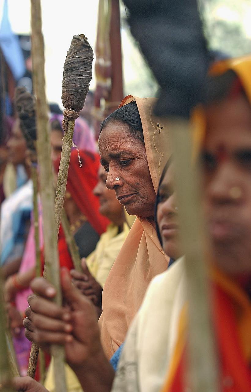 Photo via Getty : Adavasi tribal women listen to speeches at a rally in Badwani, Madhya Pradesh, India. 